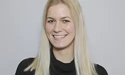 Smiling woman with long blonde hair.