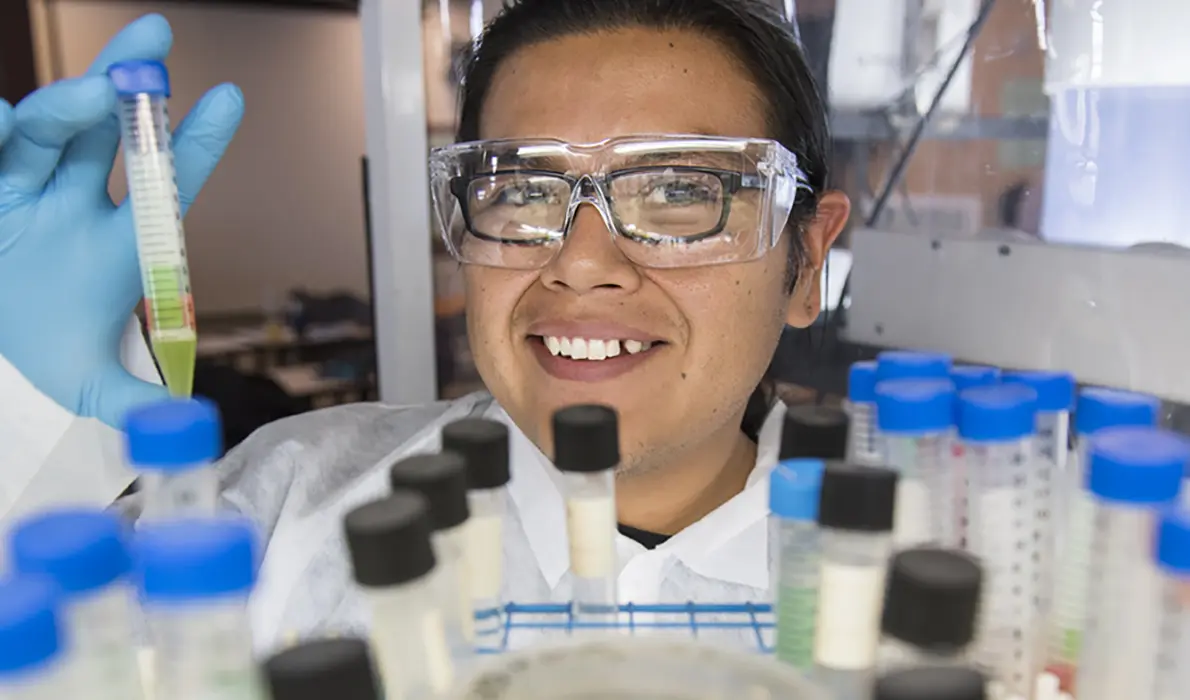 Scientist holding test tube in laboratory.