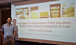 Person presenting algae research in classroom.