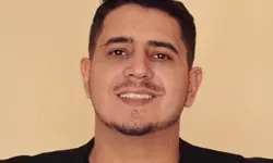 Smiling man against a plain background.