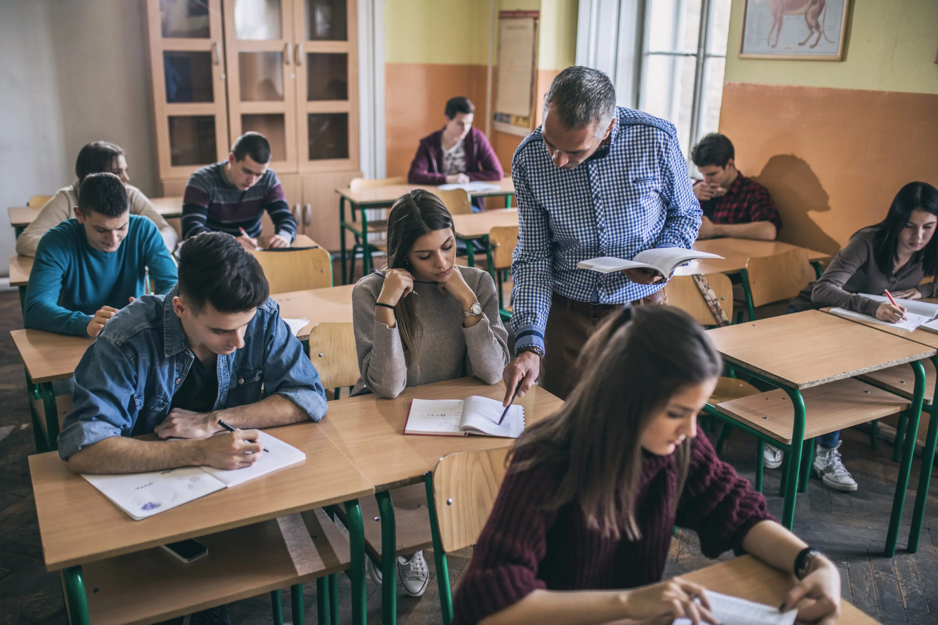 Students and teacher in a classroom setting.