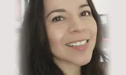 Smiling woman with long dark hair.