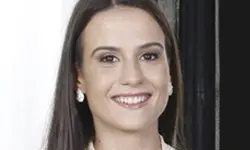 Smiling woman with long hair and earrings.