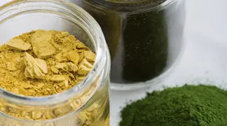 Jars of yellow and green powdered herbs.
