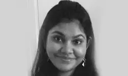 Smiling woman with long dark hair.