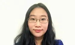 Woman with glasses and long dark hair.