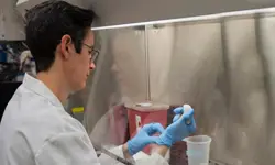 Scientist working in a laboratory setting.
