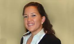 Smiling woman in professional attire portrait.