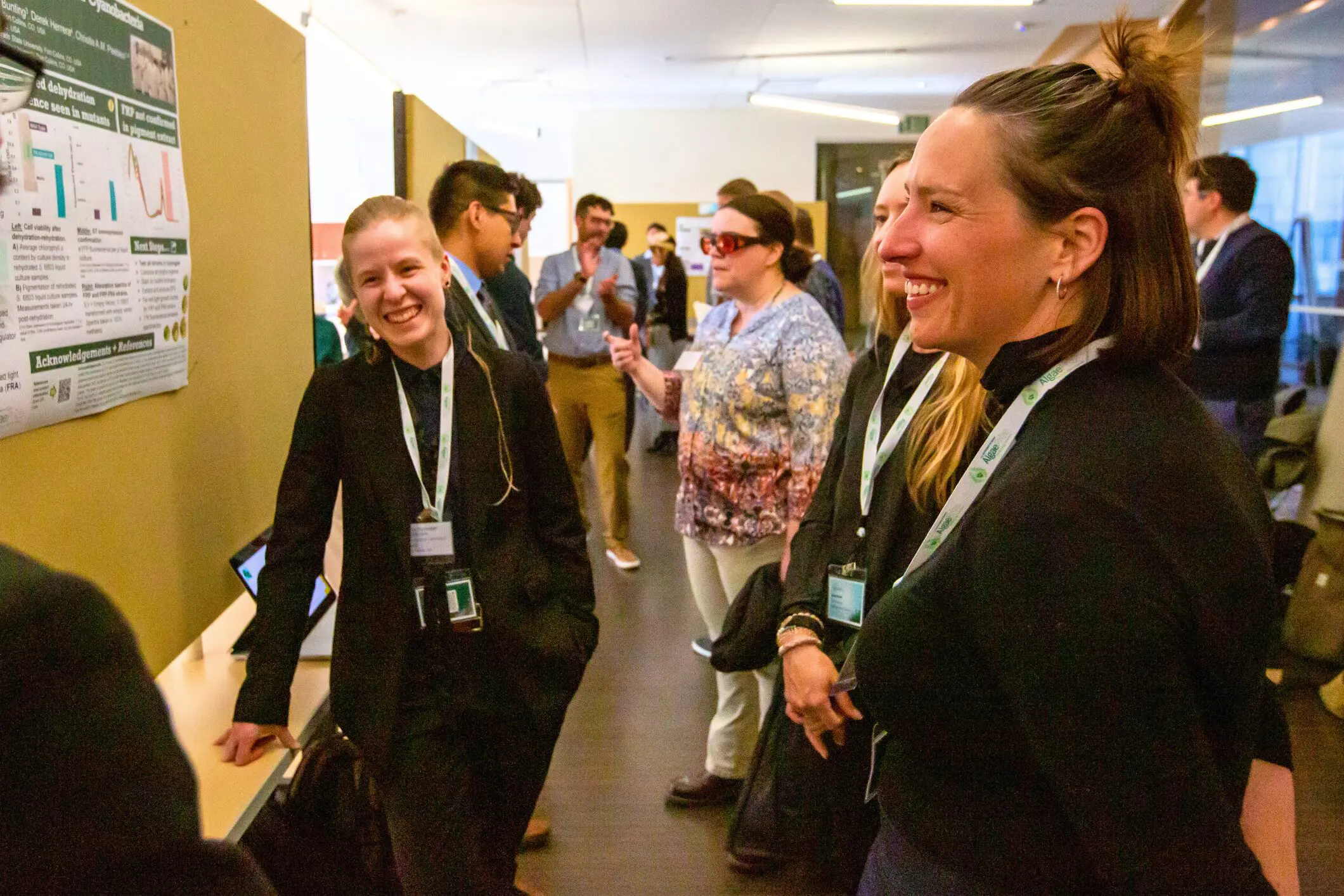 People engaged in lively conversation at an indoor event.