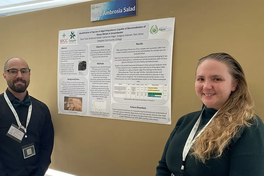 Two women presenting a scientific poster on alternative fuels.