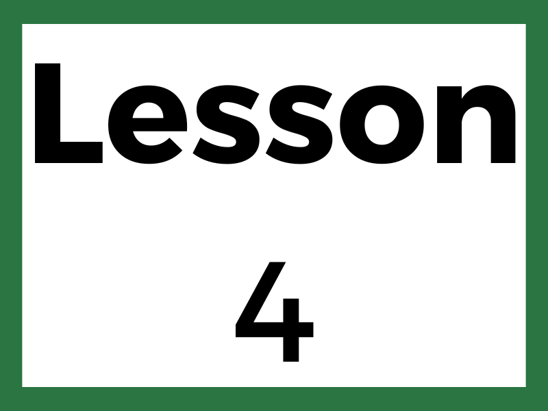 Group photo of people wearing matching shirts in front of a wooden building.