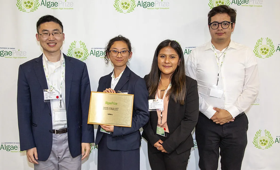 Group of professionals posing with an award at an event.